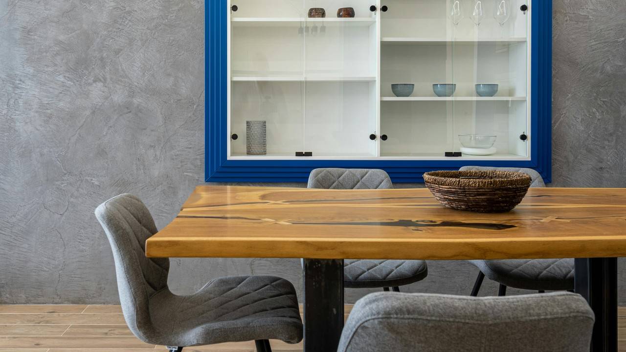 Sala de jantar com uma parede cinza ao fundo